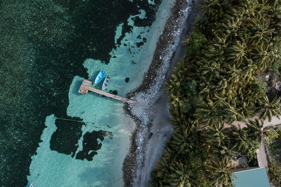 Aerial view of Aman resort overwater villa in the Maldives with private pool and crystal-clear turquoise waters, showcasing exclusive tropical luxury