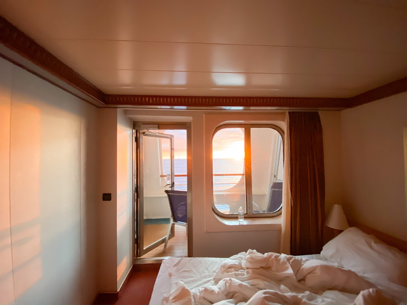 Luxurious suite interior on Antarctic expedition cruise ship with panoramic windows overlooking icebergs