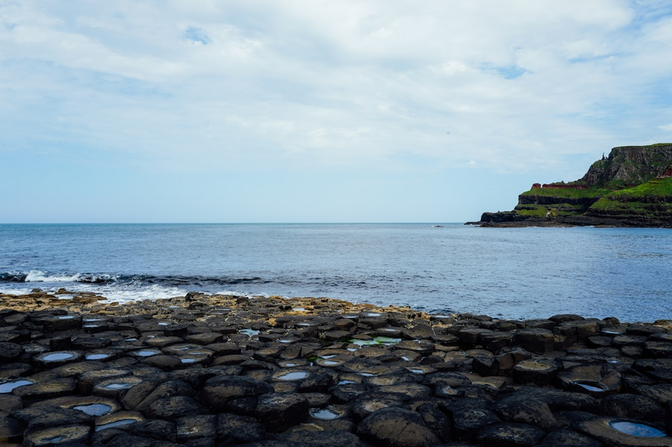 Giant's Causeway hexagonal basalt columns with tourists exploring the UNESCO World Heritage site