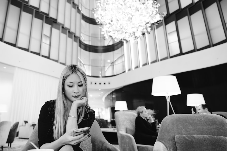 Sophisticated traveler reviewing custom travel itinerary in luxury hotel lounge with tropical views