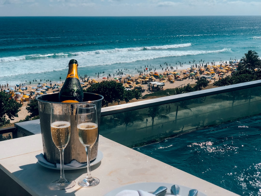 Luxury hotel suite with champagne welcome amenities and ocean sunset views
