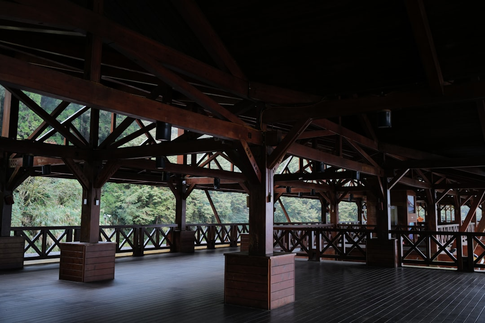 Group yoga session in open-air pavilion at luxury wellness retreat with instructor and tropical forest views