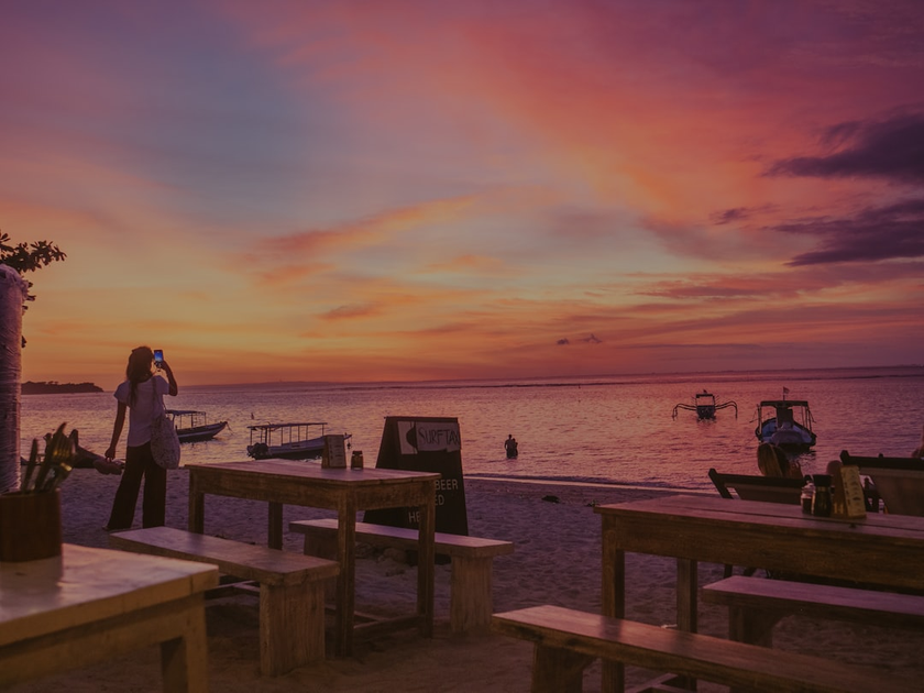 Private beach dining experience at sunset with personal chef service on exclusive island resort