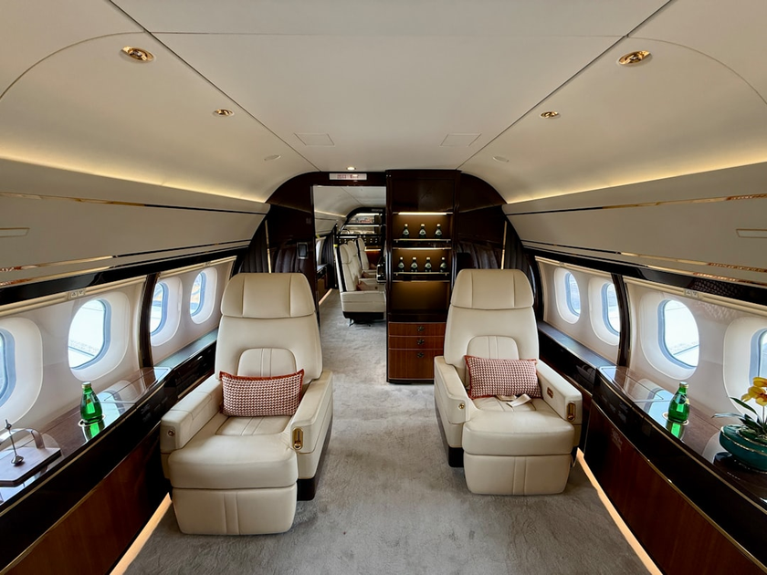 Luxurious private jet cabin interior with leather seats, gourmet dining, and premium amenities